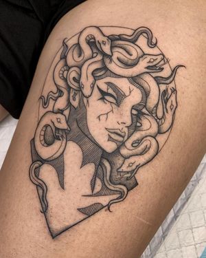 Detailed blackwork tattoo featuring a powerful medusa with a serpent, crafted by the talented artist Nikita Jade Morgan.