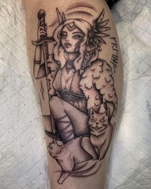 Illustrative lower leg tattoo by Nikita Jade Morgan featuring a cat, woman, and quote with lettering and necklace details.