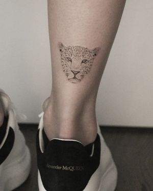 Embrace your wild side with this stunning black and gray illustrative leopard tattoo by Martyna Śliwka.