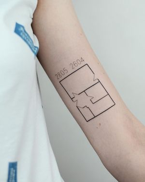Get a unique upper arm tattoo by artist Dawid Szubert featuring small lettering and illustrative pattern design.