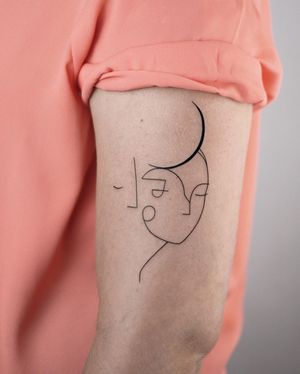 Fine line illustrative tattoo of a woman with a moon, by Dawid Szubert, on the upper arm.