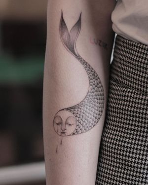 Expressive blackwork fish design on upper arm by talented artist Lena Dabska.