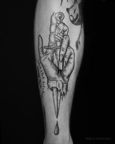 Unique blackwork forearm tattoo by Mara featuring a striking illustration of a dagger and hand design.