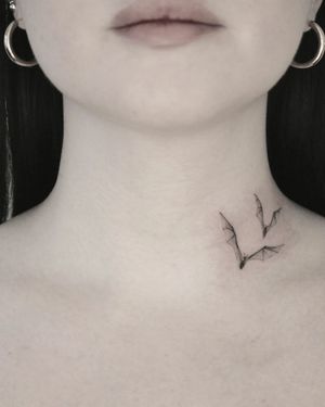Experience Martyna Śliwka's stunning fine line art with this illustrative bat tattoo on the neck.