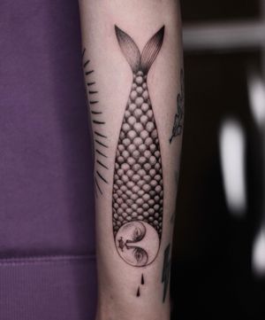 Beautiful blackwork fish tattoo on forearm by Lena Dabska. Detailed and unique design.