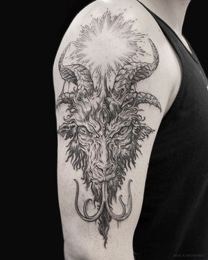 Get inked with Mara's unique blackwork, fine line, and illustrative style design featuring a devil motif with a tongue pattern on your upper arm.
