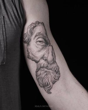 Unique blackwork design of a woman on upper arm, expertly done by tattoo artist Mara.