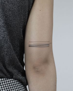 Get a stunning illustrative pattern tattoo on your upper arm by the talented artist Dawid Szubert