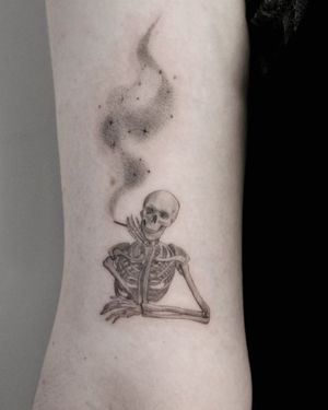 Illustrative black and gray tattoo featuring a skull, skeleton, and cigarette, by Martyna Śliwka.