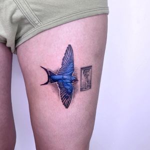 Get a stunning and detailed bird tattoo on your upper leg by the talented artist Lou. W. Perfect for nature lovers.