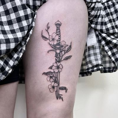 Elegant black and gray illustrative design by Lou. W combining flowers and a sword, perfect for upper leg placement.