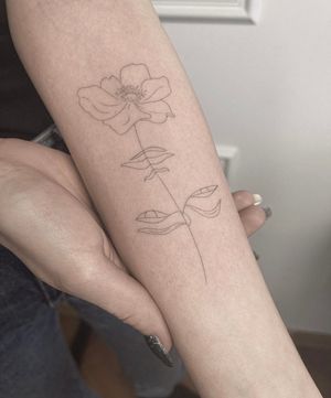 Adorn your forearm with a beautiful fine line flower tattoo by artist Dominika Gajewska.