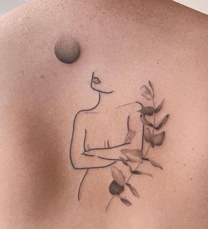 Elegant and detailed back tattoo by Dominika Gajewska featuring a woman and a leaf in fine line blackwork style.