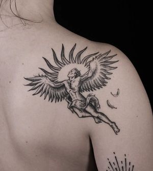 Experience the beauty of the sun, wings, and man in this upper back tattoo by Mara. Detailed blackwork style.