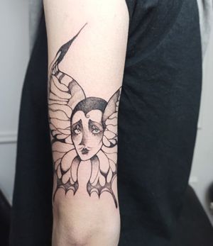 Stunning blackwork & fine line illustration of a woman with a butterfly on upper arm by Lena Dabska.