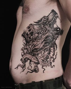 Embrace the wild with Mara's intricate blackwork design featuring a fierce wolf, piercing eye, and tangled thorns on your ribs.