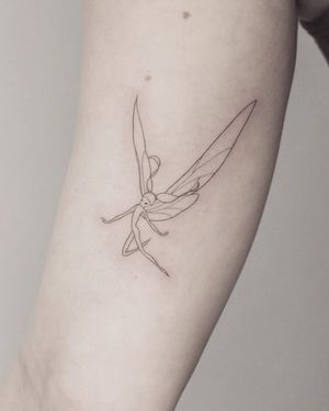 Elegant fine line design of fairy wings on the upper arm by Martyna Śliwka. Perfect for those who want a mystical touch.