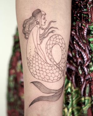 Unique blackwork and illustrative design by Lena Dabska, featuring a stunning mermaid with piercing on a woman's forearm.