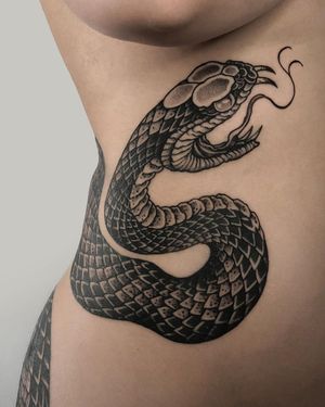Exquisite Japanese snake tattoo on ribs by FKM TATTOO, intricately detailed and beautifully crafted.