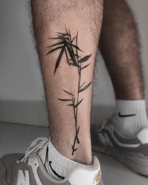 Exquisite blackwork and fine line tattoo of a geometric flower design on the lower leg by FKM TATTOO.