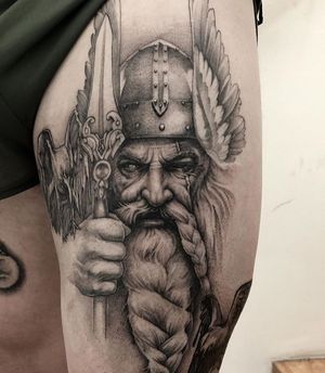 Get a fierce Viking warrior design on your upper leg in Long Beach with black and gray realism style.