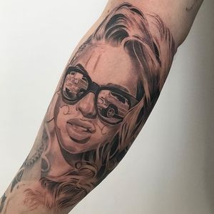 Showcase your love for Long Beach with this black and gray forearm tattoo featuring a stylish woman, glasses, and a classic car.