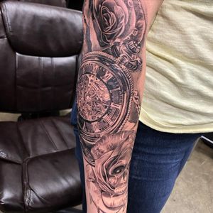 Detailed black and gray illustration of flower, skull, and clock inspired watch. Located in Long Beach, US.