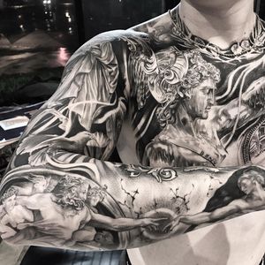 Get a stunning black and gray chest tattoo in Long Beach featuring an angelic man surrounded by intricate filigree details.