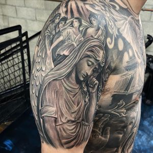Capture the beauty and power of an angelic woman with wings in this black and gray illustrative tattoo on your upper arm in Long Beach, US.