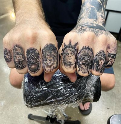 Get a stunning black and gray finger tattoo featuring a lion, skull, ship, glasses, and hat in Long Beach, US.