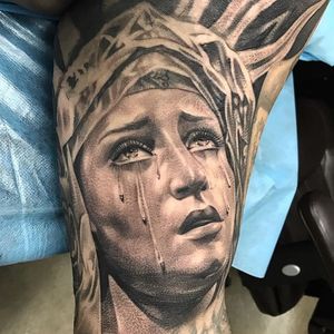 Captivating black and gray forearm tattoo featuring a realistic illustration of a woman shedding tears. Located in Long Beach, US.