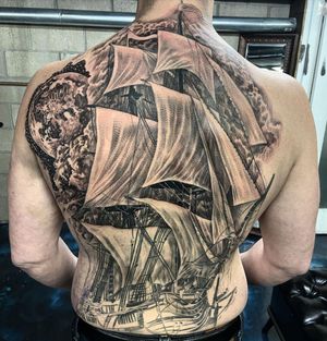 Sail through the night sky with this stunning black and gray tattoo featuring a moon and ship in Long Beach, US.