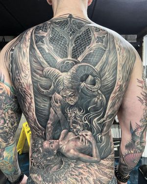 Get lost in the intricate details of this black and gray tattoo depicting a devil, angel, horns, and a woman on your back in Long Beach, US.