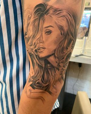 Get inked with a stunning blackwork and fine line illustrative tattoo of a woman holding a card, perfect for your upper arm placement in Long Beach, US.