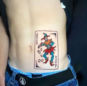 Joker playing card stomach tattoo