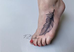 Illustrative feather tattoo on the foot in bold blackwork style by the talented artist Patrick Bates.