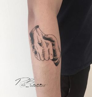 Blackwork forearm tattoo of a hand by artist Patrick Bates, merging illustration with intricate details.