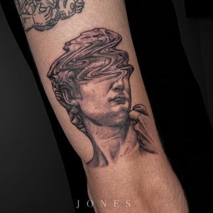 Impressive upper arm tattoo by artist Jones blending realism and illustrative blackwork styles.