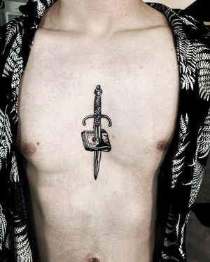 Get a bold blackwork & illustrative tattoo of a dagger with money motif on your chest by Lars.