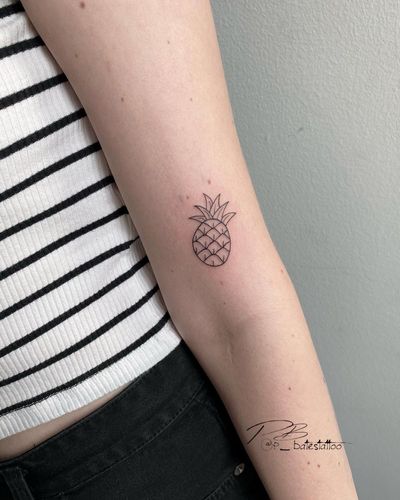 Get a stylish and detailed pineapple tattoo on your upper arm by the talented artist Patrick Bates. Express your love for tropical vibes with this fine line and illustrative design.
