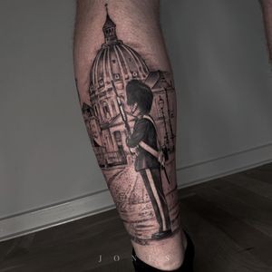 Incredible blackwork realism tattoo on lower leg by Jones, featuring a soldier, gun, and buildings in an illustrative style.