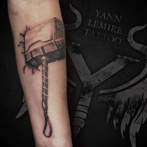Detailed black and gray illustration of Thor's hammer, Mjolnir, in realistic style by Yann.