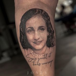 A beautiful black and gray tattoo on the lower leg featuring a girl with small lettering quote artfully done by Jones.