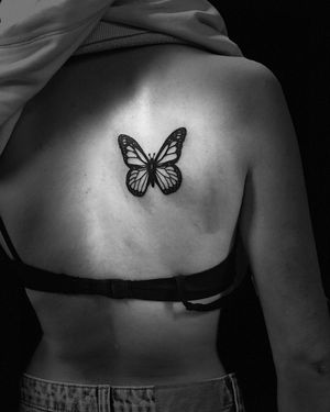 Experience the beauty of blackwork and illustrative style with this stunning butterfly tattoo by Niklas Fogh.