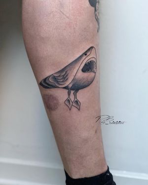 Unique blackwork tattoo featuring a bird and shark design, expertly done by Patrick Bates