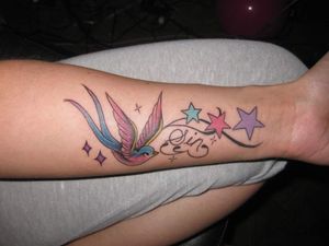Swallow with stars and flourishes with SIN worked in. I wanted some fun color. By Paul Chateauneuf.