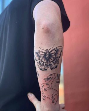 A stunning blackwork tattoo of a moth on the forearm, designed by the talented artist Yura.