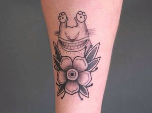 Beautiful blackwork illustration by Yura featuring a frog and flower design on the shin. Unique and bold!