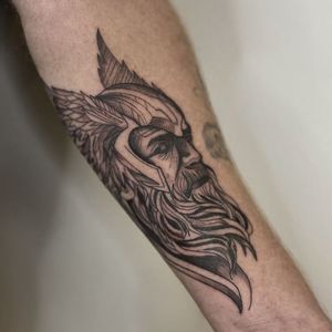 Celebrate the power of Thor and Odin with this detailed forearm tattoo by Yura, featuring a man, beard, helmet, and wings in fine line style.