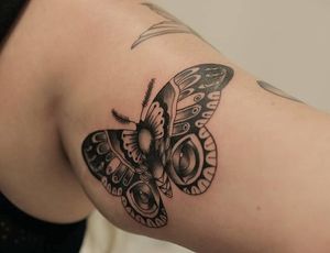 Embrace the wild and delicate beauty with this blackwork tiger and moth tattoo by Yura on your upper arm. Perfect blend of strength and grace. Dare to stand out!